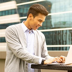 A dedicated financial advisor diligently works on his laptop, ready to provide personalized solutions.